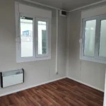 Office container kitchenette and hallway designed to maximize space efficiency and employee convenience.
