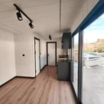 Bright container office interior with large windows creating a comfortable and productive working environment.